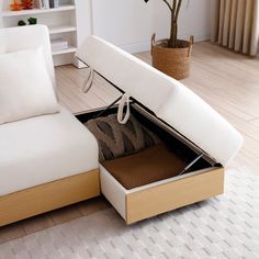 a white couch sitting on top of a hard wood floor