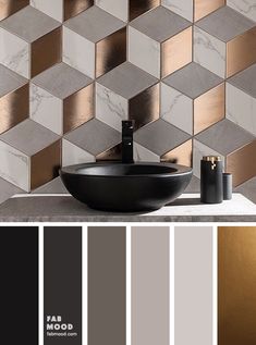 a bathroom with gold and grey tiles on the wall, black bowl sink in front of it