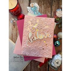 a card with the word believe on it next to some christmas decorations and other items