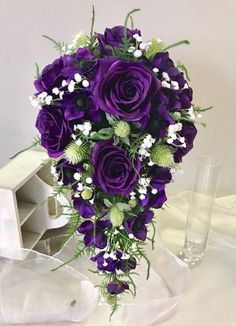 a bouquet of purple flowers sitting on top of a table