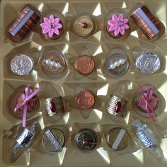 the coins are arranged on top of each other with pink ribbons and bows around them