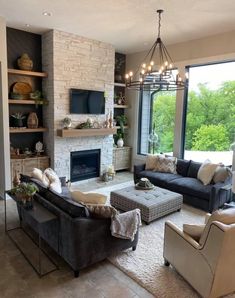 a living room filled with furniture and a fire place in front of a large window