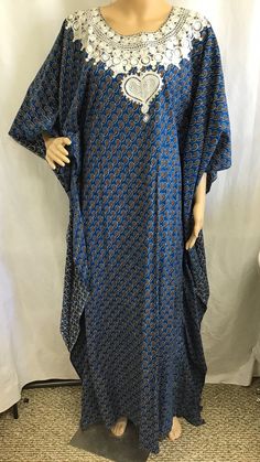 Vintage: 1960s 70s Caftan "Kaftan" Size: Medium Large Materials: Poly cotton blend  Color: Blue geometric Print Description:  Vintage Kaftan Maxi Dress.  Blue and Gold Geometric Print. Pretty white embroidery around neck line.  Very Slimming look.  High Neck.  Slip on No Zipper.   Great style wonderful look. Condition: Excellent. no tears or smells.  Please see pictures for more details Size: Not marked - Fits size small to large. Note: Slip on only No zipper.   This Kaftan is made to be more form fitting.  There is several inches of material on the outside to give it the free flowing look but is form fitting.  I have taken a picture of the dress "inside out"  To give a better idea of the fit. This is the LAST picture Please see measurements for proper fit Measurements: Shoulder 19" Chest Bohemian Floor-length Kimono For Eid, Batik Print Maxi Length Kaftan, Traditional Blue Maxi Length Abaya, Traditional Blue Maxi Dress For Eid, Blue Dabka Maxi Length Abaya, Blue Floor-length Thobe With Dabka Detailing, Blue Floor-length Thobe With Dabka, Blue Floor-length Dabka Thobe, Blue Maxi Length Kurta With Block Print