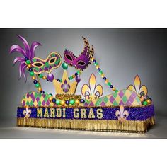 mardi gras decoration with purple and green decorations on top of the mardi gras