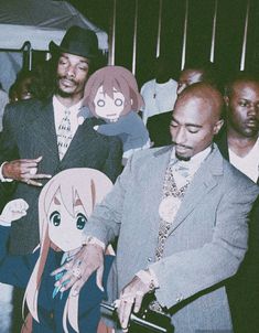 a man in a suit and tie standing next to another person with an anime character cut out on his face