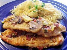 a blue plate topped with pasta and meat