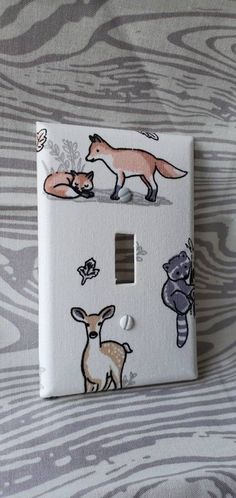 a light switch cover with animals painted on it