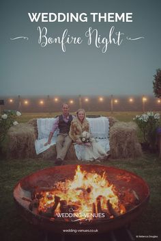 two people sitting next to each other in front of a fire pit with hay bales