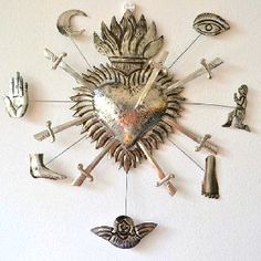 a large metal clock with many different items on it