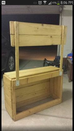 a wooden bench sitting next to a car in a garage