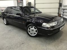 a black car is parked in a garage