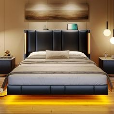 a large bed sitting on top of a wooden floor next to two night stands and lamps