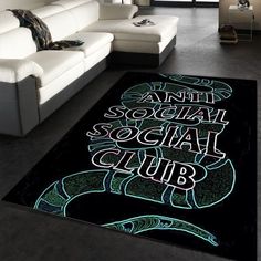 a living room with a couch and rug that says anti social social club on it