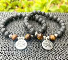 This beautiful paring is great for grounding your energy and reminding you that just like the lotus flower, you too can emerge from your muddy water into the light 🪷 🩶8mm Lava Stone and Tigers Eye Beads🩶Silver Lotus Flower Charm and silver accent beads. 🩶Essential oils can be added to the lava stones (2 Available) Silver Beaded Bracelets With 8mm Beads For Meditation, Silver Healing Bracelet With 108 Beads, Silver Spiritual Bracelet With 8mm Beads, Silver Beaded Bracelets For Meditation, Holistic Silver Bracelets With Round Beads, Holistic Silver Bracelet With Round Beads, Silver Bracelet With 108 Beads For Healing, Silver Beaded Bracelet For Meditation, Silver Beaded Bracelets With Gemstone Beads For Meditation