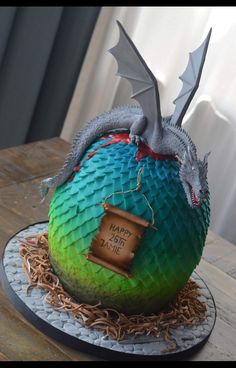 a cake with a dragon sitting on top of it