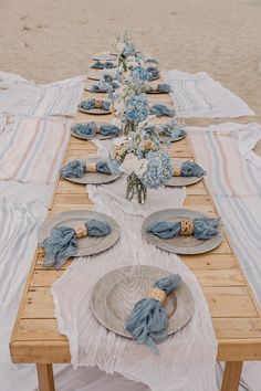 a long table with plates and napkins on it