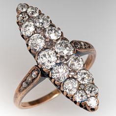 This lovely circa mid-to-late Victorian era silver topped 14k yellow gold ring. The navette shaped gallery is accented with sixteen (16), semi-bezel/bead set, old European cut diamonds and six (6), bead set, rose cut diamonds. The shoulders of the ring are each accented with three (3), bead set, rose cut diamonds. The ring measures 26.2mm at the top, rises 5.5mm above the finger, tapering to 1.4mm wide and 0.8mm thick at the base of the shank. It is currently a size 7. A few of the accent diamonds are chipped but this is not visible without magnification. Victorian Jewelry With 17 Jewels In Marquise Cut, Vintage Marquise Cluster Ring With Diamond Accents, Antique Marquise Jewelry With Single Cut Diamonds, Antique Jewelry With Marquise Single Cut Diamonds, Antique Marquise Diamond Ring, Antique Marquise Rose Cut Diamond Jewelry, Antique Marquise Diamond Ring With Accents, Antique Marquise Collectible Ring, Victorian Marquise Ring For Anniversary