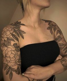 a woman with tattoos on her arm and shoulder