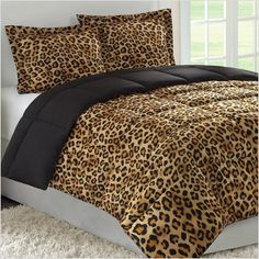 a leopard print comforter set on a bed