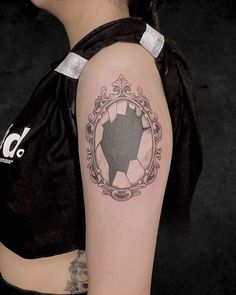 a woman with a tattoo on her arm has a black and white photo in the shape of a pig