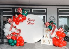 balloons and candy canes are on display in front of the entrance to a baby shower