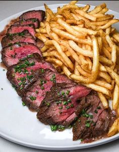 steak and french fries on a white plate