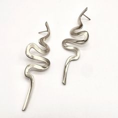 Make a statement in these swirling, snake-like earrings that drip from your ears like ribbons of cascading water. Lightweight but impactful, these modern Medusa earrings catch the light in the most elegant, seductive way. They, who have seen her, own, they never did trace More Moving Features in a sweeter face - Ovid Product Info: These earrings are 2.25" (58mm) tall and have a fixed post backing. Local Color, Sterling Silver Earrings, Yellow Gold, Sterling Silver, Silver, Gold