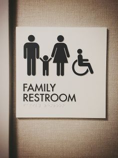 a family restroom sign on the wall