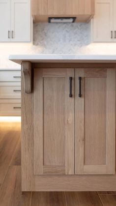 a kitchen with wooden cabinets and white counter tops in the middle of the flooring