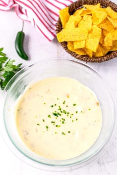 a bowl of dip with tortilla chips on the side