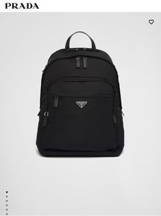 Prada black backpack with luggage clip Luxury Nylon Bags With Logo Patch, Luxury Nylon Backpack With Zipper Closure, Luxury Backpack With Functional Pockets, Modern Travel Backpack With Logo Patch, Designer Nylon Backpack For Travel, Classic Nylon Business Backpack, Designer Black Nylon Backpack, Classic Nylon Backpack With Zipper Pocket, Luxury Nylon Backpack With Leather Trim