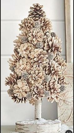 a pine cone christmas tree sitting on top of a table