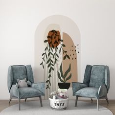 a living room with two chairs and a wall mural in the background that says toys