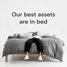 a person laying on a bed with the words our best assets are in bed