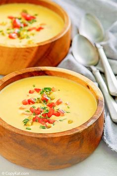 two wooden bowls filled with soup on top of a table