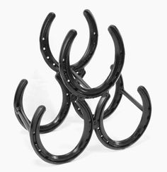 four black horseshoes are stacked on top of each other