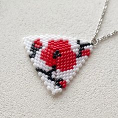 💖 Add a pop of color to your outfit with this unique handmade boho red flower seed bead necklace pendant. The triangle beaded pendant features a floral design that is perfect for plant lovers. This beaded choker is the ideal Christmas gift for her, adding a touch of nature-inspired beauty to any look * MATERIALS * It is made of high quality Japanese seed beads. Because of it's shape there is no space between each bead in work. Each jewelry looks like it's made of metal not of glass This pendant Handmade Red Beaded Flower Necklaces, Handmade Red Flower Beaded Necklaces, Red Flower-shaped Beaded Necklaces For Gifts, Red Flower-shaped Beaded Necklace For Gift, Red Flower-shaped Beads For Gifts, Flower Seed Bead Necklace, Flower Seed Bead, Red Boho, Christmas Gift For Her