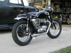 a black motorcycle parked in front of a truck