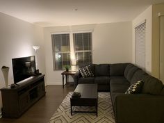 a living room filled with furniture and a flat screen tv