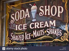 the sign for soda shop ice cream is on display in the store's window