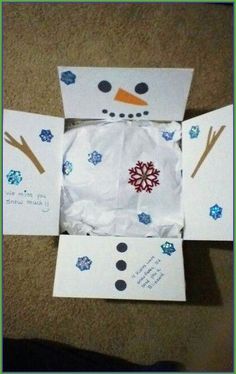 an open box with snowmen on it and some writing on the inside of it