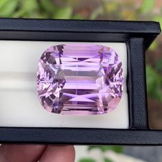 a pink diamond is displayed in a black box