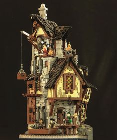 a toy house made out of legos on a black background with text overlay