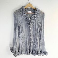 Y2K Grey Semi Sheer Ruffle Textured Babydoll Blouse Shirt  Button closure, has a Ruffle collar and long sleeves. Textured, lightweight semi sheer material. Stain on sleeve as seen in last pic  Brand - Pretty Angel  Tag size - Medium Seen on size Small Measurements (laying flat) Chest - 18 in Length - 25 in Sleeve - 24 in #fairygrunge #whimsygoth #greyblouse #ruffle #babydollshirt Fitted Long Sleeve Blouse With Ruffles, Fitted Ruffle Button-up Shirt, Long Sleeve Ruffled Summer Shirt, Spring Tops With Buttons And Ruffled Collar, Spring Blouse With Ruffled Collar And Buttons, Fall Blouse With Ruffled Collar And Buttons, Babydoll Shirt, Amarillo Tx, Babydoll Blouse