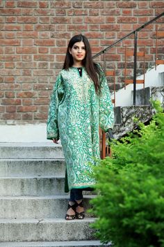 A stunningly marvellous Pheran. This Pheran features intricate Kashmir Aari embroidery on all-over the front side and on the sleeves.- - - - - - - - - - - - - - - - - - - - Product Details- Condition: Brand New (made to order)- Style: Phiran Tunic- Fabric: Pure Wool- Colour: Green- Embroidery: Jaal Aari Work- Embroidery Colour: Multi-Colour- Standard Length: 40" | Can be customized- Care Instructions: Dry Clean Only**If you want the Tunic to be shorter or longer, just send us a message, and we w Green Jamawar Long Sleeve Traditional Wear, Embroidered Long Sleeve Jamawar Salwar Kameez, Embroidered Jamawar Fabric For Eid, Ceremonial Embroidered Salwar Kameez, Green Ceremonial Dupatta, Embroidered Long Jamawar Salwar Kameez, Long Traditional Wear With Chikankari Embroidery On Jamawar, Bohemian Jamawar Kurta With Chikankari Embroidery, Green Long Kurta With Chikankari Embroidery