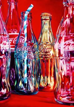 several glass bottles are lined up against a red background