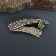 This unique sterling silver shawl pin is contemporary in design and of heirloom quality. The hammered silver is antiqued to enhance the texture and show off the beautiful Ethiopian Opal. I love how versatile this brooch is.  It can be worn vertically, diagonally or horizontally. It looks great holding a scarf or a shawl in place or on the lapel of a jacket.  A wonderful gift for women or add it to your own collection. Shipping: This brooch is finished and ready to ship in 1-2 business days. All Silver Shawl, Diamond Charm Necklace, Precious Metal Clay Jewelry, Silver Ankle Bracelet, Shawl Pin, Metal Clay Jewelry, Unique Jewelry Gifts, Anniversary Gift For Wife, Scarf Pin