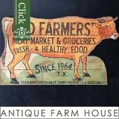 an antique farm house sign with a cow on it's side and the words farmers meat market & groceries