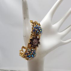 Embrace A Burst Of Vibrant Elegance With This Multi-Color Rhinestone With Gold Links Bracelet. The Bracelet Features A Dazzling Array Of Rhinestones In A Spectrum Of Colors, Each Intricately Set Within Chic Gold Links. Measuring A Graceful 7.5 Inches In Length, This Bracelet Gracefully Adorns Your Wrist With A Delightful Blend Of Glamour And Playfulness. The Gold Links Add A Touch Of Sophistication To The Vibrant Hues, Creating A Versatile Accessory Suitable For Various Occasions. Illuminate You Blue Jeweled Bracelets For Party, Blue Crystal Bracelet For Party, Vintage Blue Bracelets For Party, Blue Jeweled Party Bracelets, Blue Crystal Bracelet With Rhinestones For Party, Blue Rhinestone Crystal Bracelet For Party, Links Bracelet, Gold Link Bracelet, Gold Jewelry Fashion