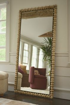 a large mirror sitting in the middle of a living room